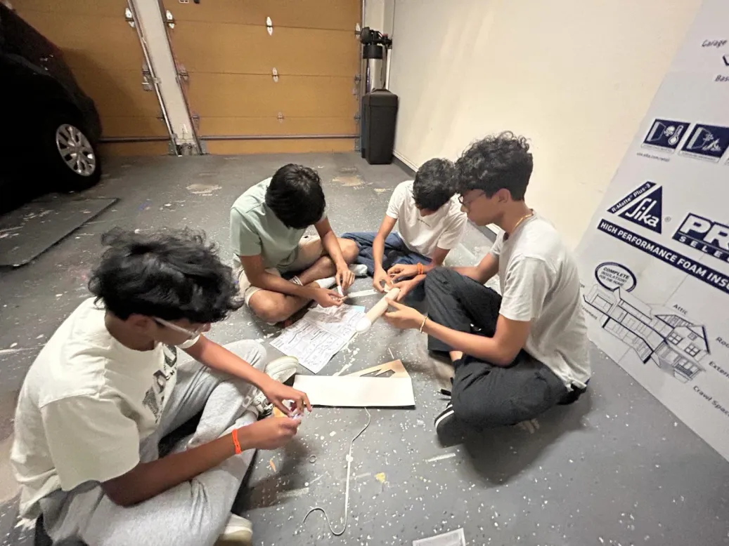 Knights Rocketry team members working on the rocket body.